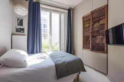 Un ou plusieurs lits dans un hébergement de l'établissement Appartement chic près de l'Arc de Triomphe