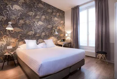 Un ou plusieurs lits dans un hébergement de l'établissement Hôtel Jeanne d'Arc Le Marais