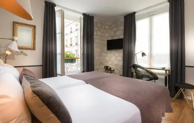 Un ou plusieurs lits dans un hébergement de l'établissement Hôtel Jeanne d'Arc Le Marais