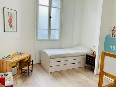 Un ou plusieurs lits dans un hébergement de l'établissement Appartement cosy et familial Paris