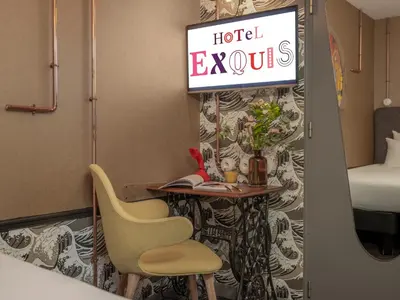Un ou plusieurs lits dans un hébergement de l'établissement Hôtel Exquis