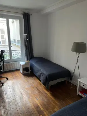 Un ou plusieurs lits dans un hébergement de l'établissement Appartement Ternes - Arc de Triomphe