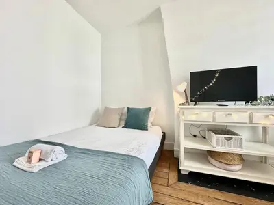 Un ou plusieurs lits dans un hébergement de l'établissement New 702 Suite Piscine - Cosy Apartment Paris Center