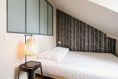 Un ou plusieurs lits dans un hébergement de l'établissement Grand appartement cœur du Marais - dernier étage