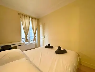 Un ou plusieurs lits dans un hébergement de l'établissement Cozy appart 15Mn Champs-Élysées