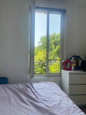 Un ou plusieurs lits dans un hébergement de l'établissement Notre appartement vue sur les Buttes Chaumont