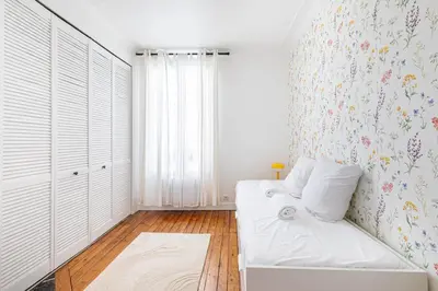Un ou plusieurs lits dans un hébergement de l'établissement GuestReady - Charming Nest near Paris