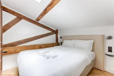 Un ou plusieurs lits dans un hébergement de l'établissement Mykeypers Luxury and Design Loft 2BR 6P with AC Bastille