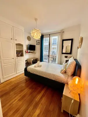 Un ou plusieurs lits dans un hébergement de l'établissement Cozy apartment Paris 18th