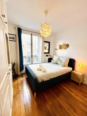 Un ou plusieurs lits dans un hébergement de l'établissement Cozy apartment Paris 18th
