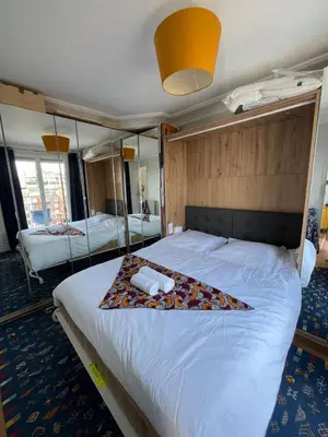 Un ou plusieurs lits dans un hébergement de l'établissement Appartement 8 personnes - terrasse sur espaces verts - vue Tour Eiffel