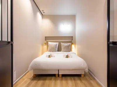 Un ou plusieurs lits dans un hébergement de l'établissement Magnificent apartment - 2BR 4P - bourse