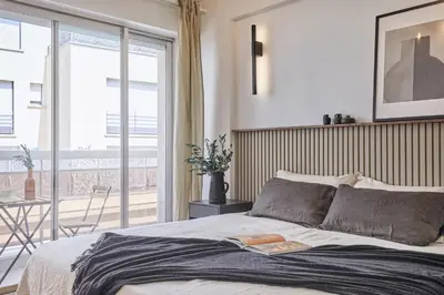 Un ou plusieurs lits dans un hébergement de l'établissement Sanoa - 3 chambres et balcon à Muette / Passy