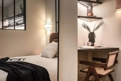 Un ou plusieurs lits dans un hébergement de l'établissement Marguerite - Studio à Auteuil