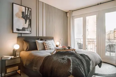Un ou plusieurs lits dans un hébergement de l'établissement Nuria - Studio et balcon à Auteuil