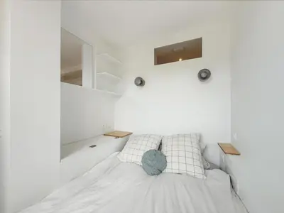 Un ou plusieurs lits dans un hébergement de l'établissement Cosy And Design Nest In Paris