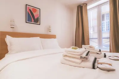 Un ou plusieurs lits dans un hébergement de l'établissement Appartement Lumineux dans le Haut Marais