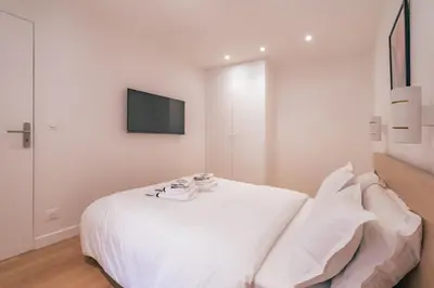 Un ou plusieurs lits dans un hébergement de l'établissement Appartement Lumineux dans le Haut Marais