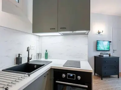 Cuisine ou kitchenette dans l'établissement Cosy Studio 2p Le Marais