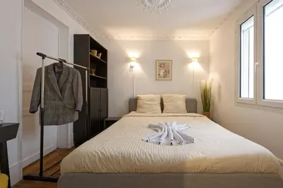 Un ou plusieurs lits dans un hébergement de l'établissement NEW appartement au cœur de Paris