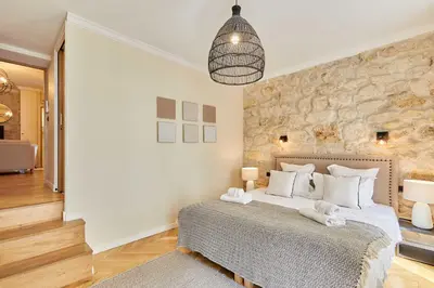 Un ou plusieurs lits dans un hébergement de l'établissement Cozy Apartment Center of Paris