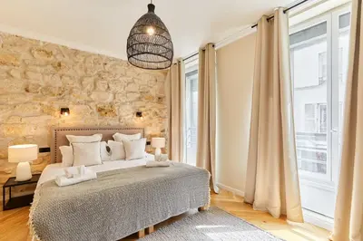 Un ou plusieurs lits dans un hébergement de l'établissement Cozy Apartment Center of Paris