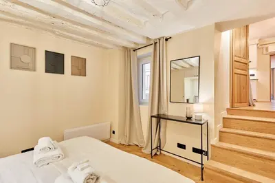 Un ou plusieurs lits dans un hébergement de l'établissement Cozy Apartment Center of Paris