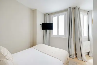 Un ou plusieurs lits dans un hébergement de l'établissement Cosy Studio 2P - Paris 01 Musée du Louvre