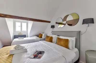 Un ou plusieurs lits dans un hébergement de l'établissement Urban Flat 117 - Parisian Apartment in the Center