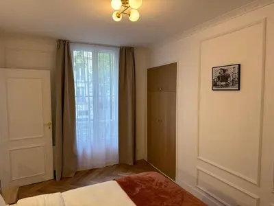 Un ou plusieurs lits dans un hébergement de l'établissement Élégant appartement Paris 17