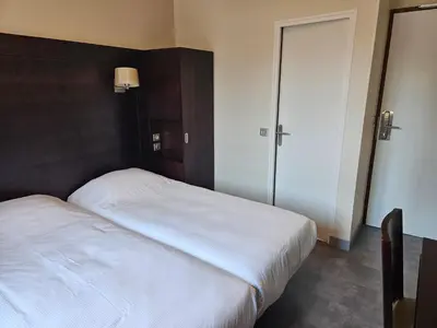 Un ou plusieurs lits dans un hébergement de l'établissement Hôtel Bellevue et du Chariot d'Or