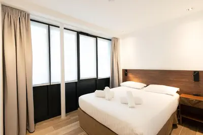 Un ou plusieurs lits dans un hébergement de l'établissement Les Suites Tour Eiffel