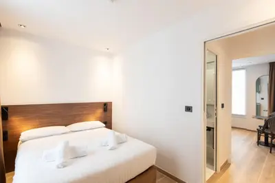 Un ou plusieurs lits dans un hébergement de l'établissement Les Suites Tour Eiffel