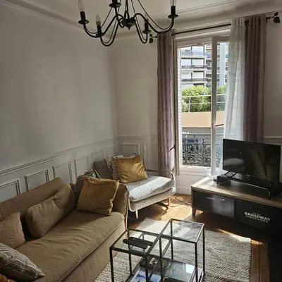 Coin salon dans l'établissement Charmant appartement à Paris Metro Nations
