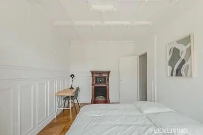 Un ou plusieurs lits dans un hébergement de l'établissement Spacious 3-bedroom apartment in Paris 14 - Alésia