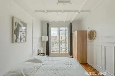 Un ou plusieurs lits dans un hébergement de l'établissement Spacious 3-bedroom apartment in Paris 14 - Alésia