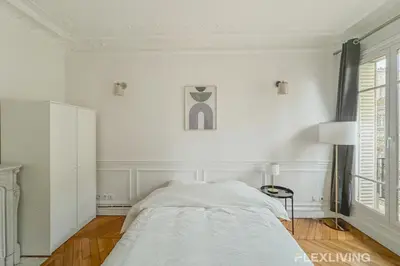 Un ou plusieurs lits dans un hébergement de l'établissement Spacieux appartement 4 chambres à Alésia