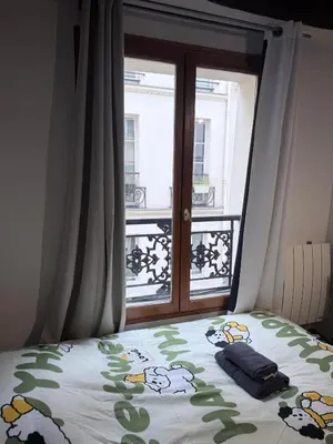 Un ou plusieurs lits dans un hébergement de l'établissement Paris Marais Sunshine Studio