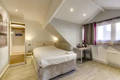 Un ou plusieurs lits dans un hébergement de l'établissement Kyriad Paris 12 - Nation