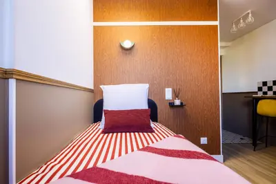 Un ou plusieurs lits dans un hébergement de l'établissement ARK Hôtel Paris Boulogne