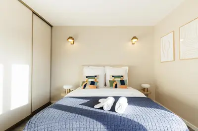 Un ou plusieurs lits dans un hébergement de l'établissement Charmant 2 chambres avec terrasse à Boulogne