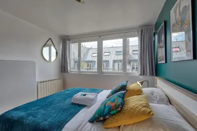 Un ou plusieurs lits dans un hébergement de l'établissement Saint-Augustin - Appartement Opéra 6P