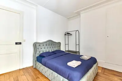 Un ou plusieurs lits dans un hébergement de l'établissement Appartement Idéal près des Quais de Seine-métro 7-6-5
