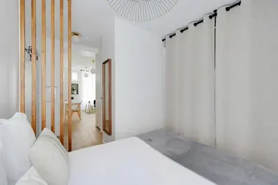 Un ou plusieurs lits dans un hébergement de l'établissement Bright Apartment 1BR-2P - Parc de la Villette