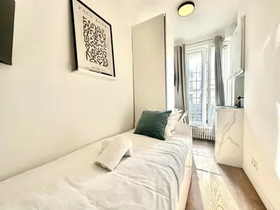 Un ou plusieurs lits dans un hébergement de l'établissement 311 Suite Prost - Cosy Apartment Paris Center