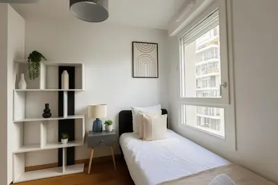 Un ou plusieurs lits dans un hébergement de l'établissement Splendide Appartement à Issy les moulineaux