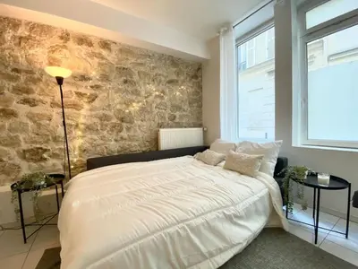 Un ou plusieurs lits dans un hébergement de l'établissement Suite 100 Belmondo Cosy Apartment Paris Center