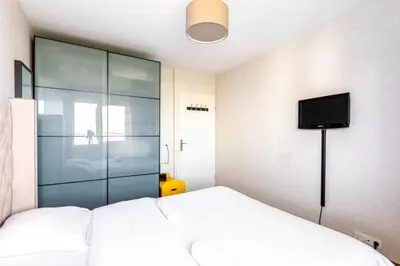 Un ou plusieurs lits dans un hébergement de l'établissement GuestReady - Cosy flat with a view of Montmartre