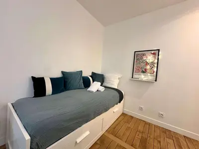 Un ou plusieurs lits dans un hébergement de l'établissement New 413 Suite Henri - Cosy Apartment Paris Center