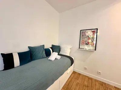 Un ou plusieurs lits dans un hébergement de l'établissement New 413 Suite Henri - Cosy Apartment Paris Center